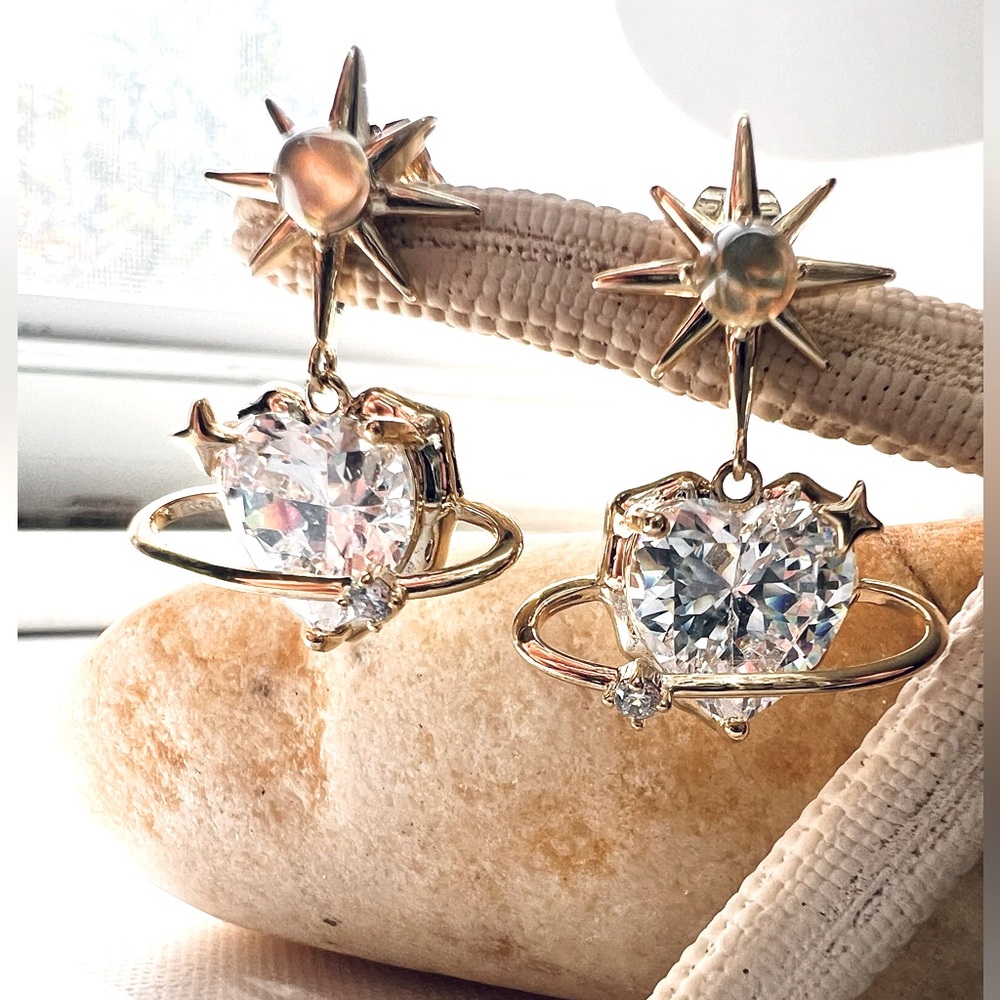 Aretes de gancho con corazón en caída de cristal traslúcido faceteado.